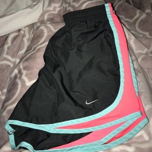 black with pink and teal/green nike shorts